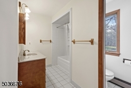 Upstairs bathroom has access from hall and master bedroom. Could easily become a master suite