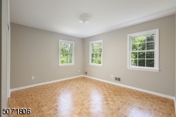 Bedroom with Parkay floors and decorative molding.