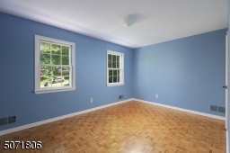 Bedroom with Parkay floors and decorative molding.