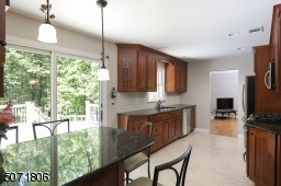 Granite counters, wood cabinets, stainless steel appliances and outdoor access.