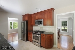 Granite counters, wood cabinets, stainless steel appliances and outdoor access.