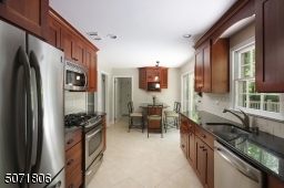 Granite counters, wood cabinets, stainless steel appliances and outdoor access.