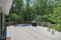 Large deck overlooks the beautiful yard.