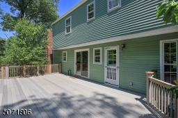 Large deck overlooks the beautiful yard.