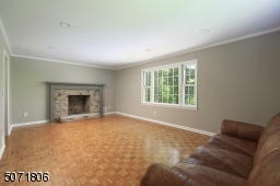 Parkay floors, decorative molding, picture window and fireplace.