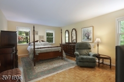 Primary bedroom with Parkay floors, WIC and ensuite bath.
