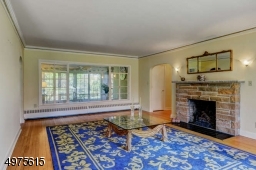 Double Picture Windows in the Living Room with Gas Fire Place overlooking 3 Season Florida Room.  Gold Leafed Crown Molding. Hardwood Floors through out 1st floor.