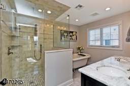Soaking Sub, Quartz vanity w/double sinks, Large shower with Bench
