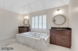 This spa-like bathroom also has an enclosed glass shower