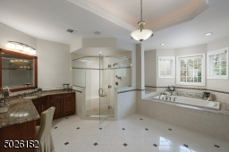 Double Vanities with Granite Counters, Oversized Shower with Dulal Shower Heads and Frameless Glass Door, Radiant Heat Flooring
