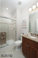 Vanity with Granite Countertop, Stall Shower with Glass Door