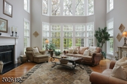 2 Story Ceiling Height, Wall of Windows, Wood Burning Fireplace, Hardwood Floors
