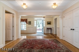 Middle foyer leads w/powder room and double closet