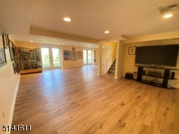 Ground level has two sets of French doors leading to the side yard. Plenty of storage, cedar closet not pictured.