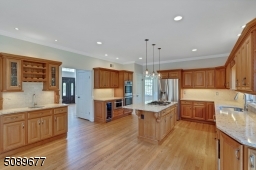 It has everything! A wet bar, wine refrigerator, microdraw, double oven, cooktop, dishwasher and stainless steel refrigerator. What more can you ask for?