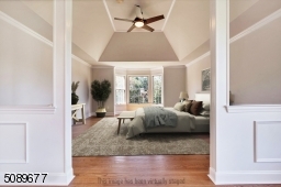 The elegant tray ceiling and bay window make the main suite grand