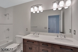 This bathroom is located in the hallway. The clean updated bathroom has two sinks and great space.
