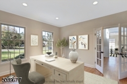 The first-floor office has elegant glass doors and large windows which lets in a ton of light.