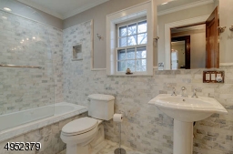 Jetted tub, marble tile, double sinks