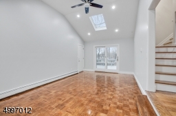 Family room with high ceilings and skylights. A sliding door that open to the deck & overlooks the large backyard. An amazing outdoor living space