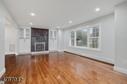 Stunning living space.Architecturally pleasing details, hardwood floors, custom moldings, recessed lighting throughout, brand new windows and doors