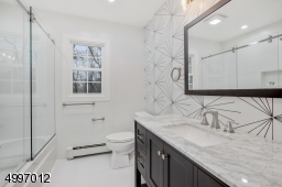 Full Second floor large designer bath with a shower over bathtub, enclosed with a frameless glass sliding shower door, decorative wall porcelain tile & custom linen closet. Located right next to optional second laundry room