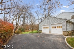 Newly paved driveway with Belgium block borders & new landscaping.