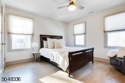 Features hardwood floors, deep baseboard moldings, 2 exposures of windows, ceiling fan and double fitted closet