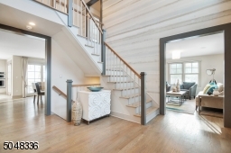 The double-height Foyer features a modern staircase and is a completely open concept.
