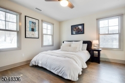 Features hardwood floors, deep baseboard moldings, ceiling fan and double fitted closet