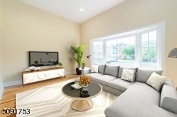 Sunken family room with bay window, new hard wood floors, 12 foot ceilings and recessed lights.