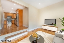 Sunken family room view leading into the kitchen. The family room has bay window, new hard wood floors, 12 foot ceilings and recessed lights