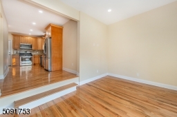 Sunken family room view leading into the kitchen. The family room has bay window, new hard wood floors, 12 foot ceilings and recessed lights