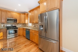 Newly renovated kitchen with new cabinets, new appliances, and new hardwood floors.