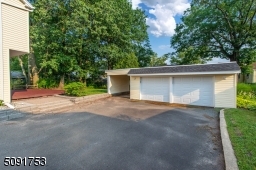 2 car oversized garage and attached carport. garage has is powered with electric with wifi operated garage door openers and touch combination key pads for access.