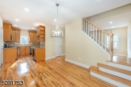 Dining room with french doors leading to the deck. Dining room has new hardwood floors, recessed lighting, and access to stairs leading to 2nd floor.