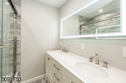 Master bathroom with custom shower doors, touch screen mirrors recessed lighting