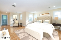 Large master bedroom that has walk in closet along with private bathroom.