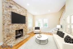 living room with new hardwood floors recessed lighting and allows access to 2nd floor stairs, sunken family room, and to the kitchen. Functioning fireplace