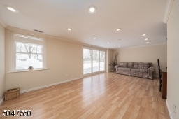 Large recreation area with door leading to level yard and patio