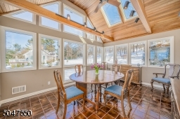 Sun filled dining room with skylights