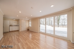 Expansive recreation area, half bath and storage room
