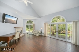 Enjoy the sitting area in the master bedroom while warming up next to the gas fireplace.