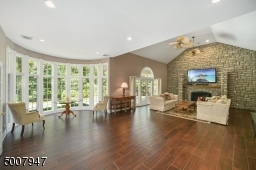 Enjoy the view of the patio, back yard, and pond from all areas of the family room.