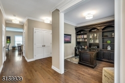 Foyer featuring hardwood floors and double coat closet