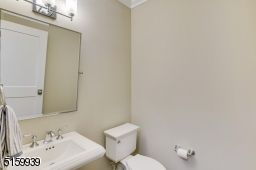 Powder Room with a white pedestal sink and three light sconce