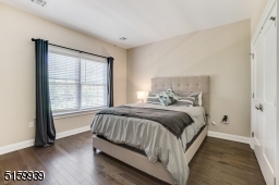 Bedroom 2 with hardwood floors, a double window and a double closet