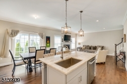 Chef's Kitchen featuring hardwood floors, recessed lights, and a Dining Area with direct access via glass sliders to the paver patio.