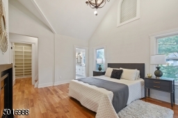 Retreat to this luxurious master suite with soaring ceilings, feature chandelier, fireplace, spa-like marble bath, walk-in closet, extra closet and a secret bonus tower loft studio space.