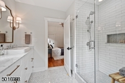 Enjoy the luxury of this walk-in shower with marble floors, handmade-look subway tile, large marble shampoo niche, custom shower glass and Kohler plumbing fixtures.  Designed by Clear Space Home.